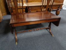 A mahogany flap sided sofa coffee table.