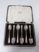 A set of six cased silver teaspoons retailed by Reid and Sons, 43g.