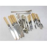 A collection of knives and forks with ivory/mother of pearl handles,