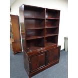 A mid 20th century mahogany bookshelves, fitted double door cupboard beneath.