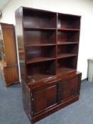 A mid 20th century mahogany bookshelves, fitted double door cupboard beneath.