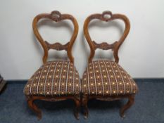 A pair of antique carved beech French dining chairs.