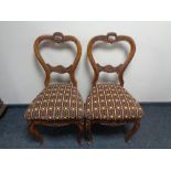 A pair of antique carved beech French dining chairs.