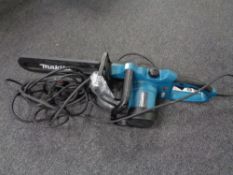 A Makita electric chain saw.