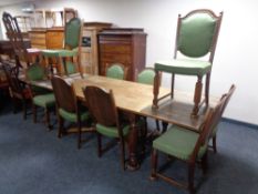 A 20th century oak pull out dining table together with a set of ten matching chairs upholstered in