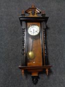 A 20th century mahogany Vienna wall clock with brass and enamel dial.