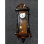 A 20th century mahogany Vienna wall clock with brass and enamel dial.