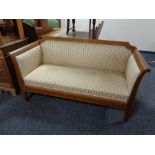 An early twentieth century inlaid mahogany framed settee in Regency stripe fabric