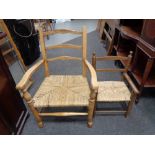 Two 20th century beech framed rush seated chairs.