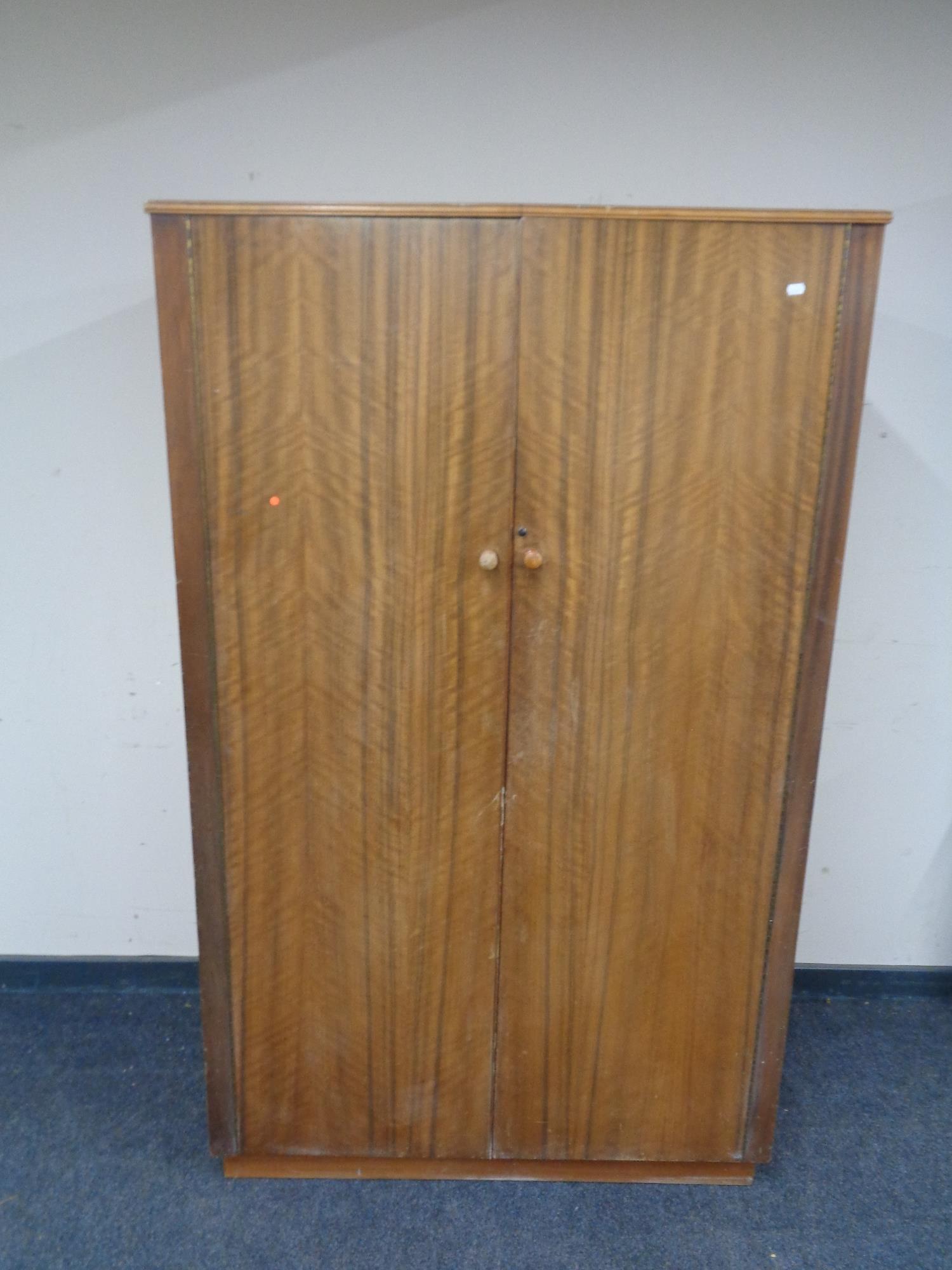 A mid 20th century teak double door wardrobe.