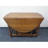 An Edwardian oak barley twist gate leg table.