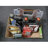 A box containing cased Black and Decker drill, Black and Decker jigsaw, nail door locks,