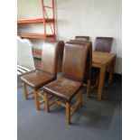 A contemporary oak rectangular dining table together with a set of eight high backed dining chairs