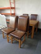 A contemporary oak rectangular dining table together with a set of eight high backed dining chairs