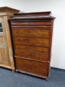 A 19th century continental mahogany seven drawer chest (as found).