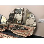 A frameless flower-head mirror,