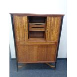 A mid 20th century CWS teak shutter door correspondence cabinet, fitted cupboard beneath.