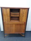 A mid 20th century CWS teak shutter door correspondence cabinet, fitted cupboard beneath.