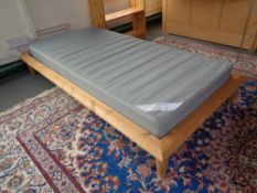An Ikea pine 3' bed frame with interior together with a set of pine bookshelves