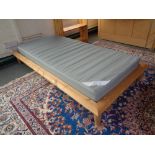 An Ikea pine 3' bed frame with interior together with a set of pine bookshelves