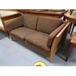 A mid century teak framed two seater settee in brown fabric