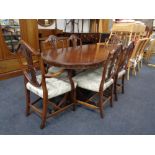 A Regency style mahogany extending twin pedestal dining table together with a set of six shield