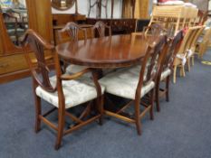 A Regency style mahogany extending twin pedestal dining table together with a set of six shield