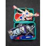Two boxes containing assorted toys to include electronic guitars, die cast vehicles,