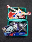 Two boxes containing assorted toys to include electronic guitars, die cast vehicles,