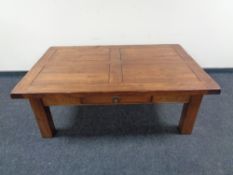 A hardwood rectangular coffee table, fitted a drawer.