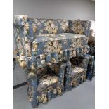 An early twentieth century three piece lounge suite in blue floral fabric