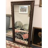 A 5' x 2' bronzed mirror