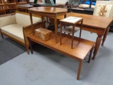 A mid century teak coffee table together with a walnut table,