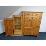 A contemporary pine cabinet, fitted cupboards and four drawers,