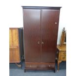 A Stag Minstrel double door wardrobe, fitted drawer beneath.