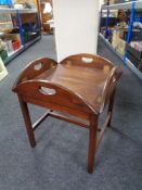 A square butler's tray on stand.