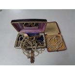 Two boxes containing assorted costume jewellery to include coin bracelets, pearl necklaces,
