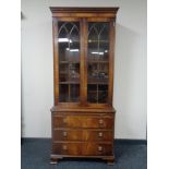 A Regency style mahogany double door bookcase with glazed doors,