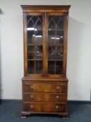 A Regency style mahogany double door bookcase with glazed doors,