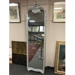 A silvered crested mirror, height 207 cm.