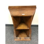 A solid oak Arts and Crafts bookcase with carved plinth and angular shelves, height 65 cm,