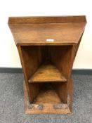 A solid oak Arts and Crafts bookcase with carved plinth and angular shelves, height 65 cm,