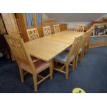 A contemporary ash refectory extending dining table with two leaves together with a set of eight