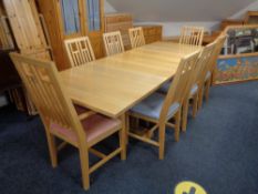 A contemporary ash refectory extending dining table with two leaves together with a set of eight