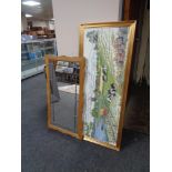 A blond oak framed leaded glass mirror together with a gilt frame tapestry depicting a farming