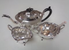 A three piece silver plated tea service together with a plated spoon