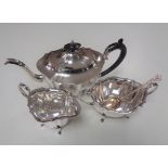 A three piece silver plated tea service together with a plated spoon