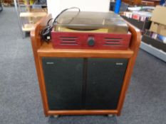 A pair of Phillips speakers in cupboard together with a Radiaiva turntable.