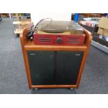 A pair of Phillips speakers in cupboard together with a Radiaiva turntable.