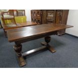 A 20th century oak refectory dining table together with a set of six ladder back chairs.